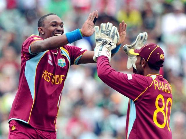 Dwayne Bravo (L) celebrates after running out Pakistan's Wahab Riaz during the 2013 ICC Champions Trophy cricket match between Pakistan and West Indies at The Oval cricket ground in London. (AFP)