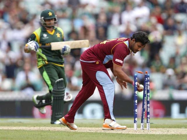 Ravindranath Rampaul runs out Pakistan's Saeed Ajmal, left, during their ICC Champions Trophy group B cricket match at the Oval cricket ground in London. (AP)