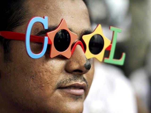 An activist of the lesbian, gay, bisexual, transgender (LGBT) rights movement wearing shades reading "COOL" participates in a "Slut Walk" in Kolkata. (AP)