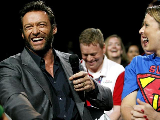 Event host Hugh Jackman talks to a shareholder in the crowd during the Walmart shareholders meeting in Fayetteville. AP