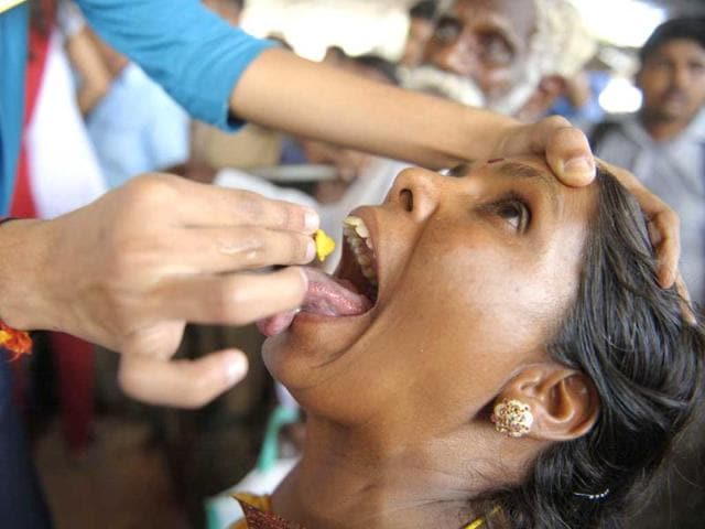 A member of the Bathini Goud family administers 'fish medicine' to a patient at the exhibition grounds in Hyderabad. (AFP)