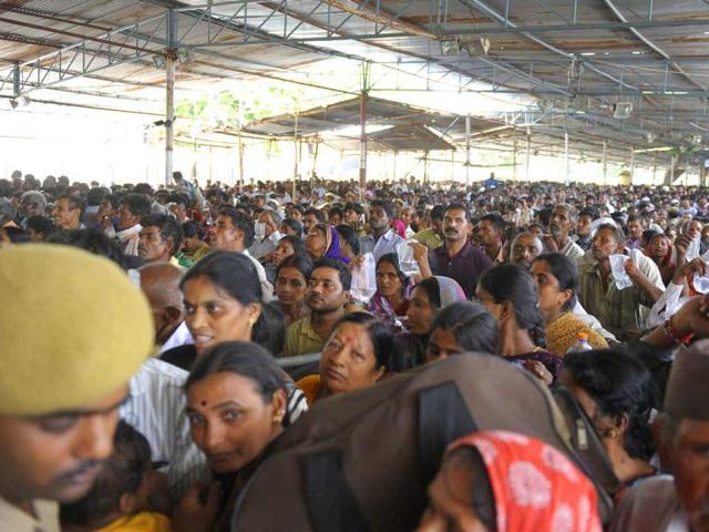 Patients wait in line to be administered 'fish medicine' by members of the Bathini Goud family at the exhibition grounds in Hyderabad. (AFP)