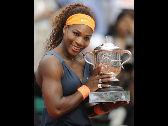Serena Williams of the US holds the trophy after defeating Russia's Maria Sharapova in two sets 6-4, 6-4, in the women's final of the French Open tennis tournament, at Roland Garros stadium in Paris. (AP)