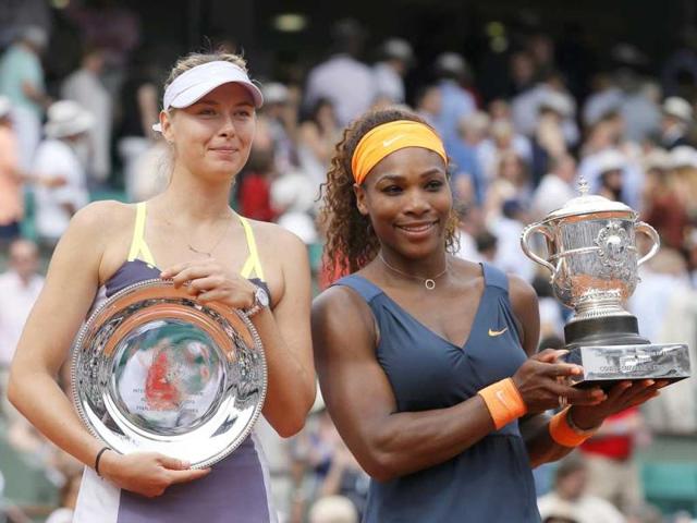 Serena Williams (R) of the US poses with her trophy next to runner-up Maria Sharapova (L) of Russia after winning the French Open tennis tournament at the Roland Garros stadium in Paris June 8, 2013. Serena Williams proved an irresistible force once more as she powered past Maria Sharapova 6-4 6-4 to win the French Open for the second time - 11 years after her first triumph. (Reuters)