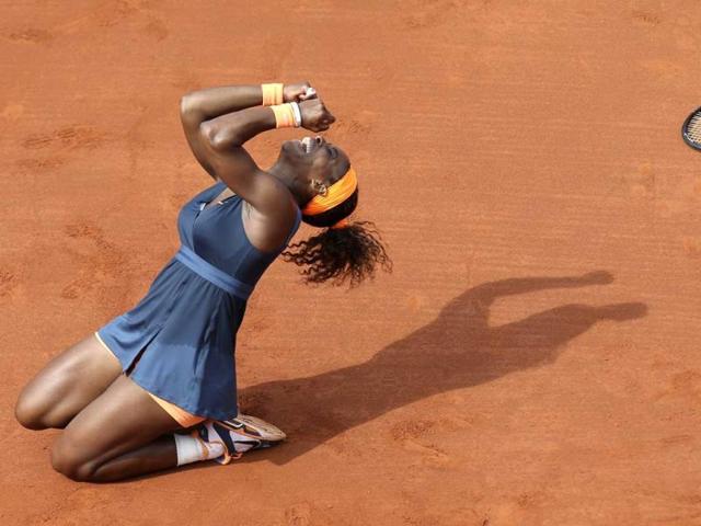 Serena Williams, of the US, celebrates as she defeats Russia's Maria Sharapova during the Women's final match of the French Open tennis tournament at the Roland Garros stadium in Paris. Williams won 6-4, 6-4. (AP)