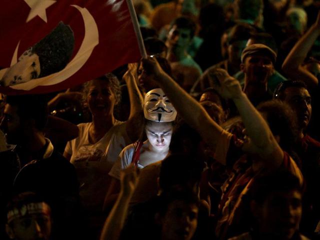 A protester uses her mobile phone during a demonstration at Taksim Square in Istanbul