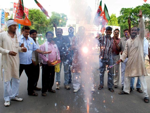BJP workers celebrate with firecrackers after Narendra Modi's anointment as BJP poll panel chief in Allahabad. PTI Photo