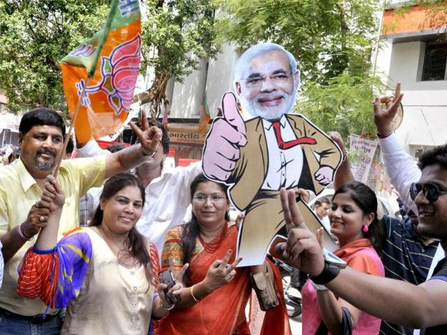 Members of fan club of Gujarat CM Narendra Modi celebrate at BJP headquarters in Ahmedabad. PTI photo
