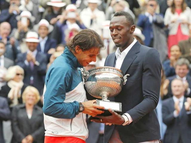 Rafael Nadal receives the trophy from Jamaican sprinter Usain Bolt after defeating David Ferrer in their men's singles final match to win the French Open final in Paris. Reuters Rafael Nadal receives the trophy from Jamaican sprinter Usain Bolt after defeating David Ferrer in their men's singles final match to win the French Open final in Paris. Reuters
