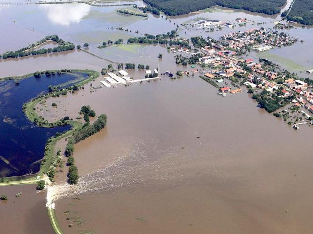 Aerial view shows houses flooded by the river Elbe after a dyke (L) broke in Fischbeck, eastern Germany. AFP