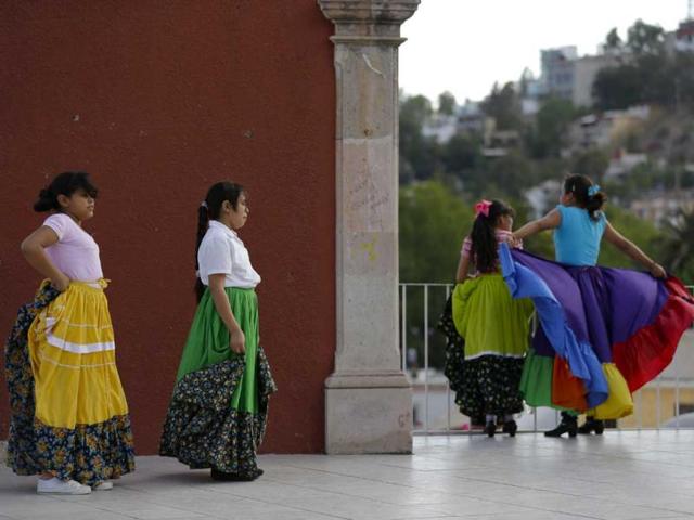 Young women take a break from practicing folk dancing in the city of Durango, Mexico. (AP)