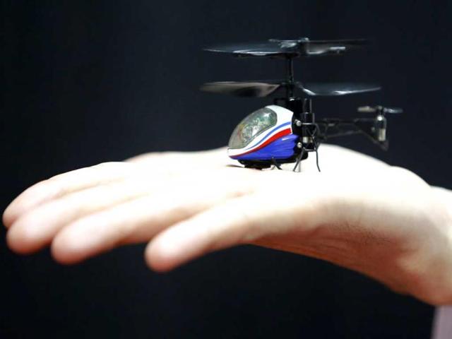 An employee from Japanese toymaker CCP Co. has the "NANO-FALCON", which according to the company is the world's smallest infrared remote-controlled helicopter, in the palm of his hand at the International Toy Show in Tokyo. Reuters photo