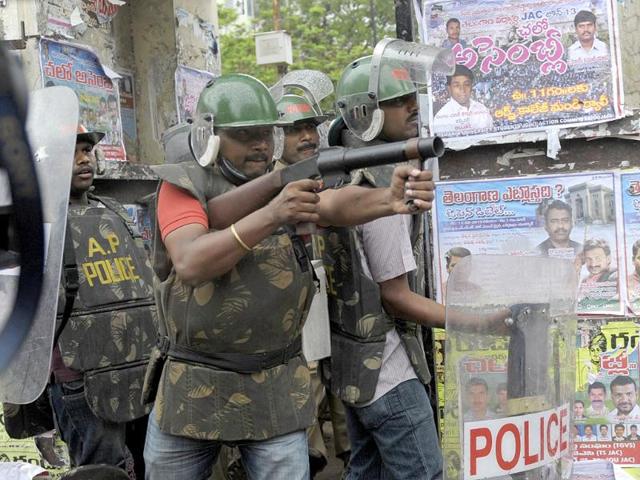 A policeman prepares to fire a tear gas shell towards Telangana Joint Action Committee (T-JAC) activists during a pro-Telangana protest in Hyderabad on June 14, 2013. AFP/Noah Seelam