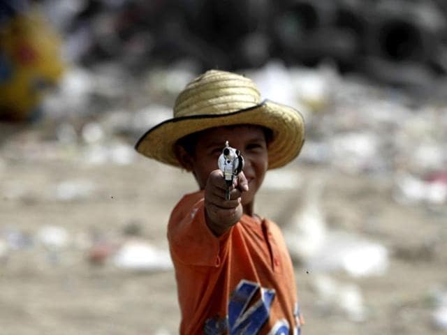 A-man-has-his-face-covered-as-he-rides-past-a-mountain-of-garbage-in-Ahmedabad-AP-Photo-Ajit-Solanki A-man-has-his-face-covered-as-he-rides-past-a-mountain-of-garbage-in-Ahmedabad-AP-Photo-Ajit-Solanki