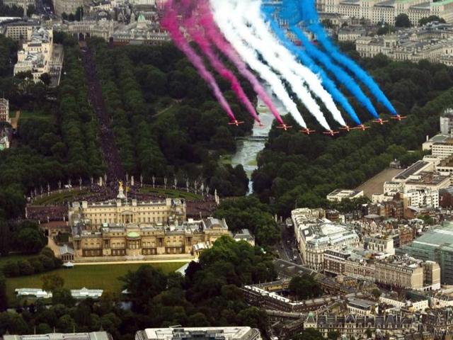 The RAF Red Arrows perform a flypast over Buckingham Palace, following the Trooping of the Colour parade, in London. Queen Elizabeth II celebrated her birthday with traditional pomp and circumstance, but without her husband by her side. AP