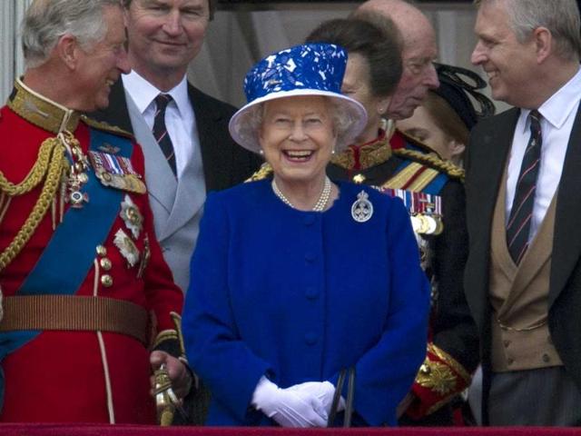 Britain's Queen Elizabeth II smiles flanked by Prince Charles, Prince of Wales (L) and Prince Andrew, Duke of York (R), ahead of the fly-past on the balcony at Buckingham Palace following the Queen's Birthday parade, 'Trooping the Colour,' in central London. AFP