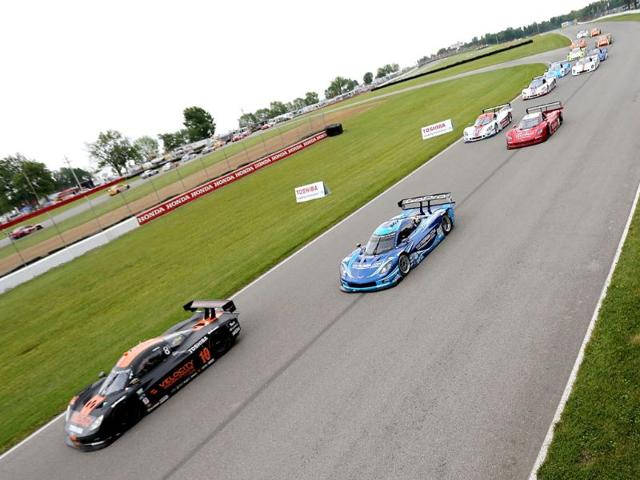 The cars race down the frontstretch at the start of the Diamond Cellar Classic at Mid-Ohio Sports Car Course in Lexington, Ohio. AFP