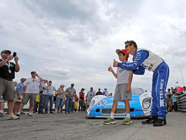 Scott Pruett greets fans in the pits before the Diamond Cellar Classic at Mid-Ohio Sports Car Course in Lexington, Ohio. AFP