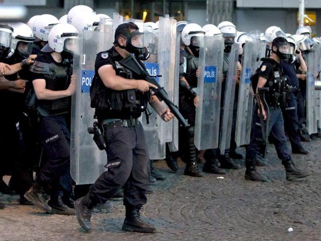 Turkish riot police advance during clashes with Gezi park protesters in Istanbul, Turkey. AP
