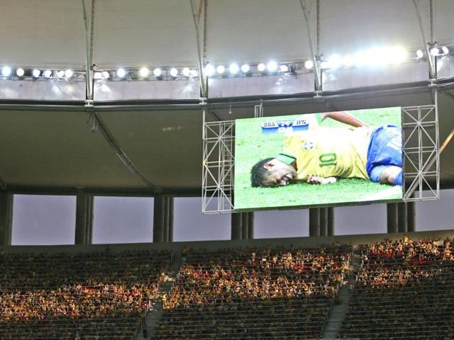 Brazil's Neymar is seen on a giant screen as he was injured during the opening match between Brazil and Japan in group A of the soccer Confederations Cup at the National Stadium in Brasilia, Brazil. AP
