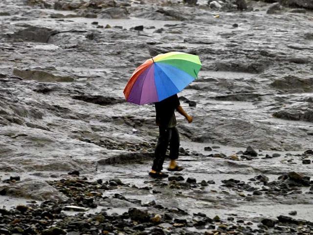 A man holds an umbrella during a monsoon shower in Mumbai. AP