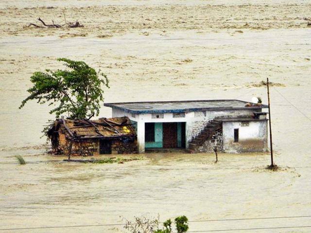 A house is seen partially submerged in the flood waters in Dehradun. AP