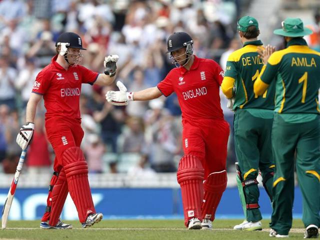 England's Eoin Morgan (L) and Jonathan Trott (C) celebrate their win against South Africa at the end of their ICC Champions Trophy semifinal cricket match at The Oval in London. AP Photo