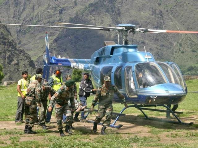 Soldiers carry the body of a flood victim after heavy rains Uttarakhand. REUTERS