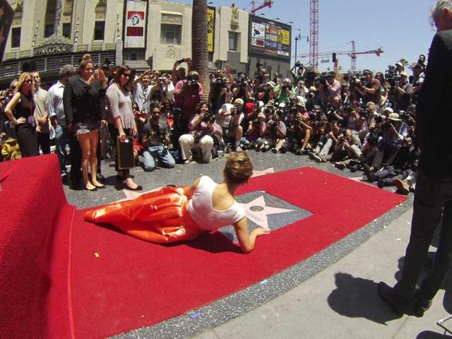 JLo, seen here posing on her star after it was unveiled on the Walk of Fame, said that the landmark moment would inspire her to work harder and dream bigger for the future. (Reuters Photo) 