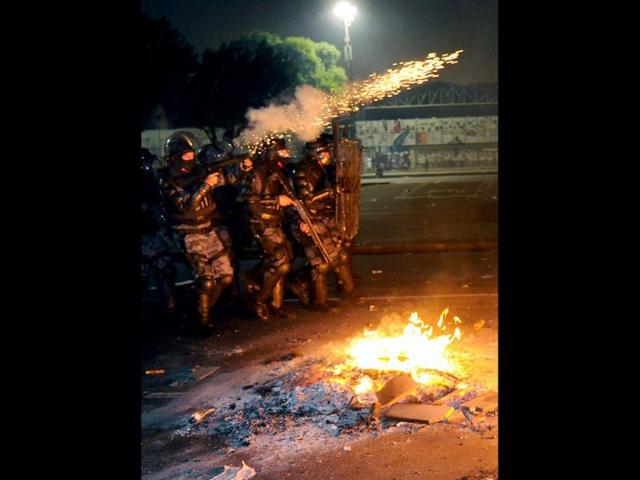 Riot policemen clash with demonstrators in downtown Rio de Janeiro during mass nationwide protests, demanding better public services and bemoaning massive spending to stage the FIFA World Cup. AFP Photo