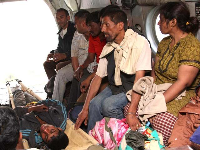Rescued flood evacuees sit in the cargo hold of an Indian Air Force Mi-17 transport helicopter flying a rescue sortie over the Kedarnath valley in Uttarakhand. (AFP/Ministry of Defence/Gurudutt Mehra)