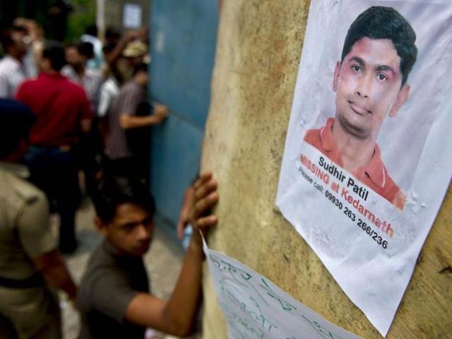 A placard showing a portrait of a missing pilgrim on a wall at the Jolly Grant Airport in Dehradun. (AFP)