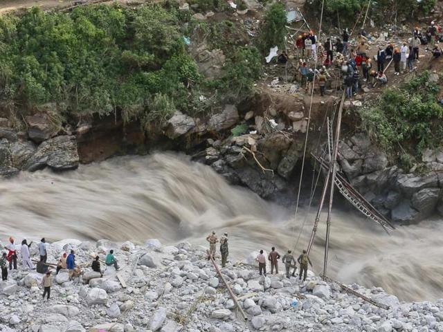Soldiers try to repair a temporary footbridge over River Alaknanda after it was destroyed, during rescue operations in Govindghat in Uttarakhand. (Reuters)