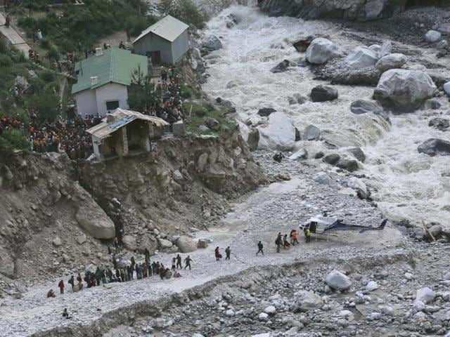 Soldiers assist survivors to board a rescue helicopter next to River Alaknanda, during rescue operations in Govindghat in Uttarakhand. (Reuters)