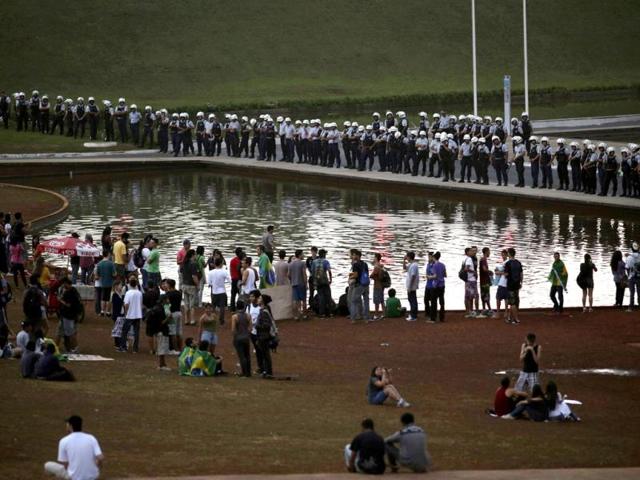 Police guard Congress as a reduced number of anti-government demonstrators appear for a protest that was postponed at the last minute for next week, in Brasilia. (Reuters)