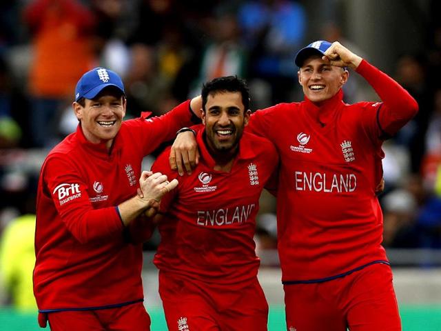 England's Ravi Bopara celebrates the wicket MS Dhoni with teammates Eoin Morgan and Joe Root during their ICC Champions Trophy final match at Edgbaston ground in Birmingham. AP
