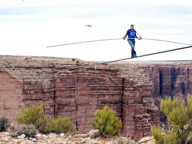 Aerialist Nik Wallenda near the end of his quarter mile walk over the Little Colorado River Gorge in northeastern Arizona. The daredevil successfully traversed the tightrope strung 1,500 feet above the chasm near the Grand Canyon in just more than 22 minutes, pausing and crouching twice as winds whipped around him and the cable swayed. (AP)