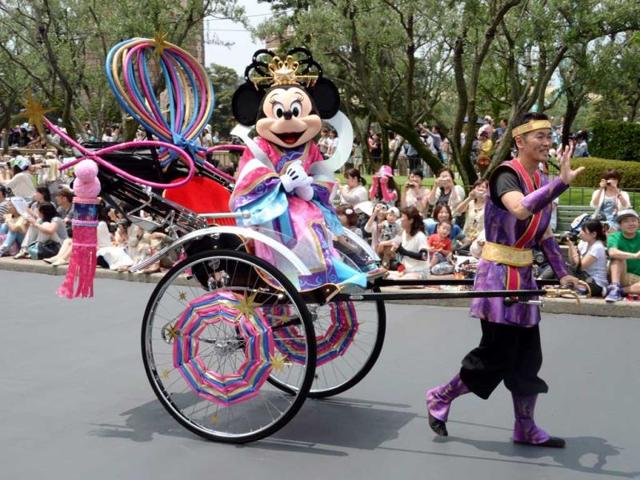 Disney character Minnie Mouse, who represents Vega the Weaver, waves to spectators from rickshaw to celebrate "Tanabata" or the Star Festival during the special parade held at the Tokyo Disneyland in Urayasu, suburban Tokyo. (AFP)