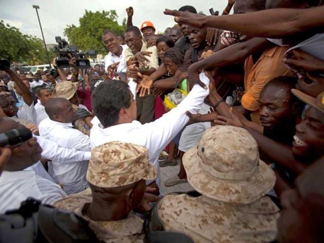 Venezuela's President Nicolas Maduro, center, greets supporters near the National Palace in Port-au-Prince, Haiti. Maduro is visiting Haiti in his first official trip to the Caribbean nation as president. (AP)