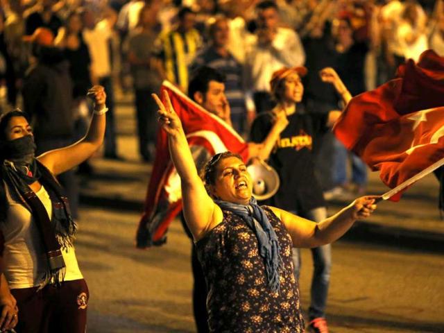 Anti-government protesters wave flags and shout slogans during a demonstration in Ankara. Turkish anti-terrorism police detained 20 people in raids in the capital Ankara in connection with weeks of anti-government protests across the country. (Reuters)