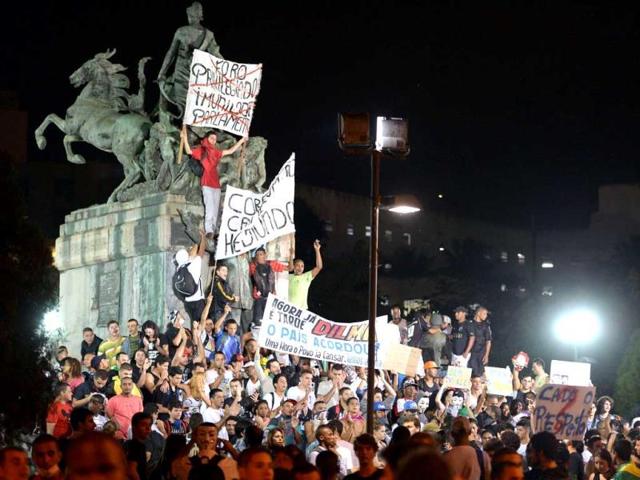 People demonstrate against government waste and corruption and the use of public funds to organize international football tournaments, in Niteroi, Rio de Janeiro State. (AFP)