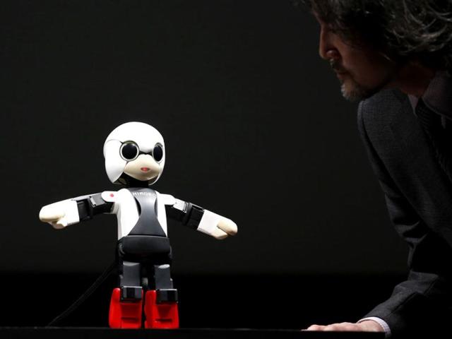 Humanoid communication robot Kirobo talks to Fuminori Kataoka, project general manager in the Product Planning Group of Toyota Motor Corp, during its unveiling in Tokyo. (Reuters)