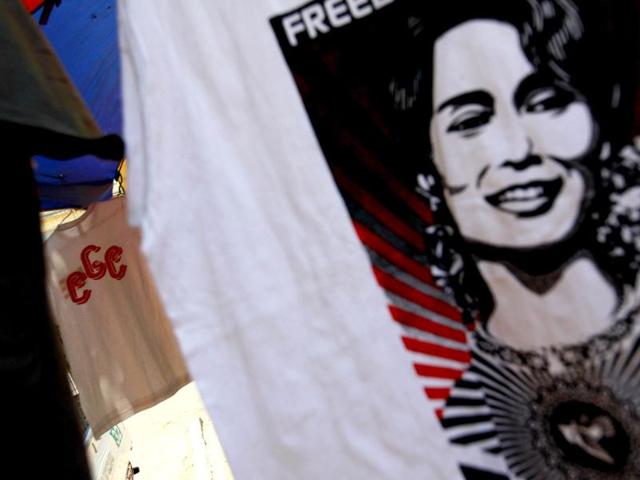 A 969 shirt is seen among National League for Democracy party shirts and Aung San Suu Kyi shirts at a shop on a street side in Yangon. Reuters
