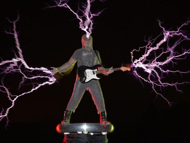 The guitarist of the band "Lightningfan" Wang Hongbin creates lightning with a Tesla Coil in their village outside of Fuzhou in China's Fujian province. AFP
