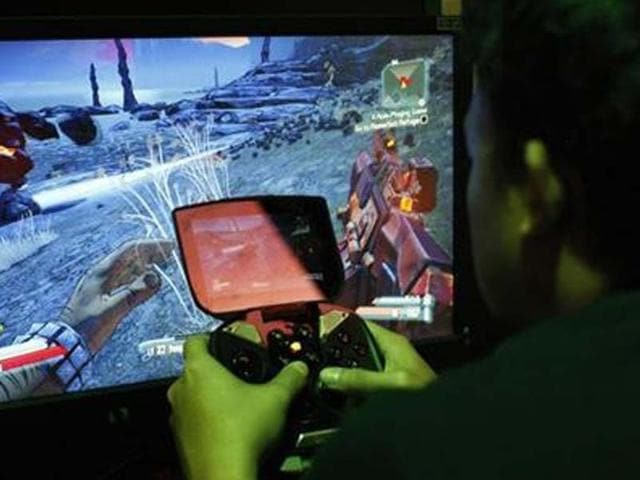 A-man-tries-a-game-at-the-Nvidia-Shield-PC-Game-Streaming-exhibit-at-E3-the-Electronic-Entertainment-Expo-in-Los-Angeles-California-Credit-Reuters-David-McNew A-man-tries-a-game-at-the-Nvidia-Shield-PC-Game-Streaming-exhibit-at-E3-the-Electronic-Entertainment-Expo-in-Los-Angeles-California-Credit-Reuters-David-McNew