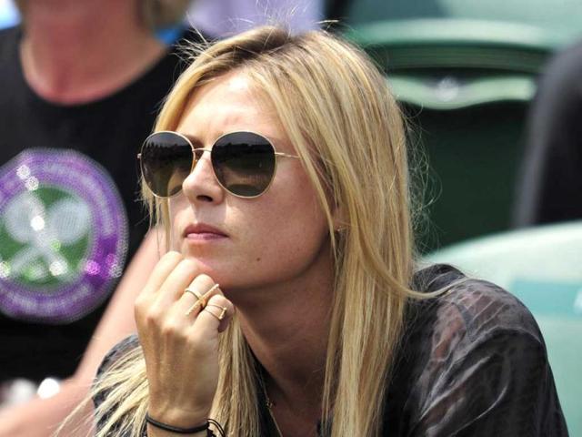 Maria Sharapova sits in the crowd watching the action between Bulgaria's Grigor Dimitrov and Slovakia's Grega Zemlja during their second round men's singles match on day four of the 2013 Wimbledon Championships tennis tournament at the All England Club in Wimbledon, southwest London. AFP Photo