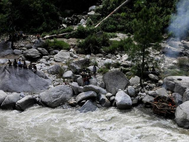 Villagers cremating the body of Laxmi Prasad (48 years) beside a river near Mayali in Uttarakhand. (HT Photo/Arijit Sen)