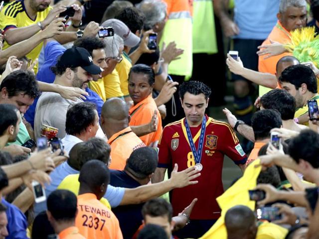 Fans greet Spain's Xavi Hernandez after the soccer Confederations Cup final match against Brazil at the Maracana stadium in Rio de Janeiro, Brazil. Spain lost 0-3. AP