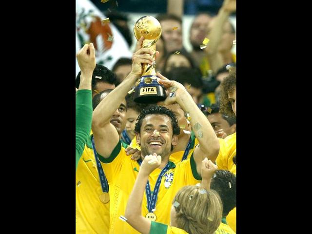 Brazil's Fred holds the trophy after winning the Confederations Cup final between Brazil and Spain at the Maracana stadium in Rio de Janeiro, Brazil. AP