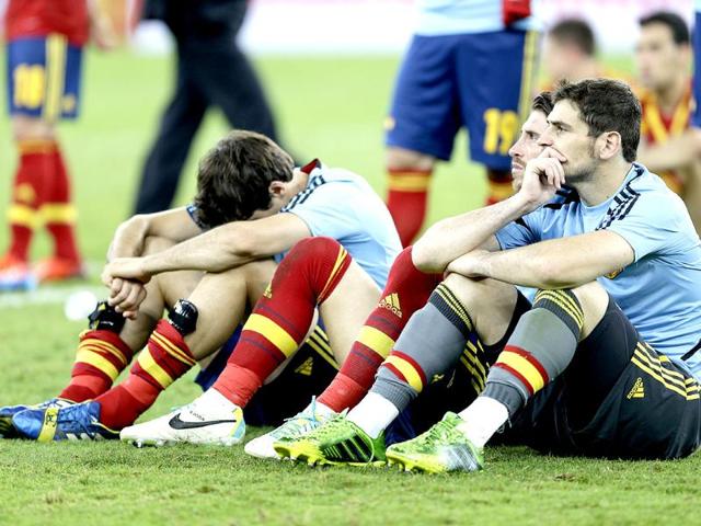 Spain's Iker Casillas seat with teammates on the grass after the Confederations Cup final match against Brazil in Rio de Janeiro, Brazil0. AP
